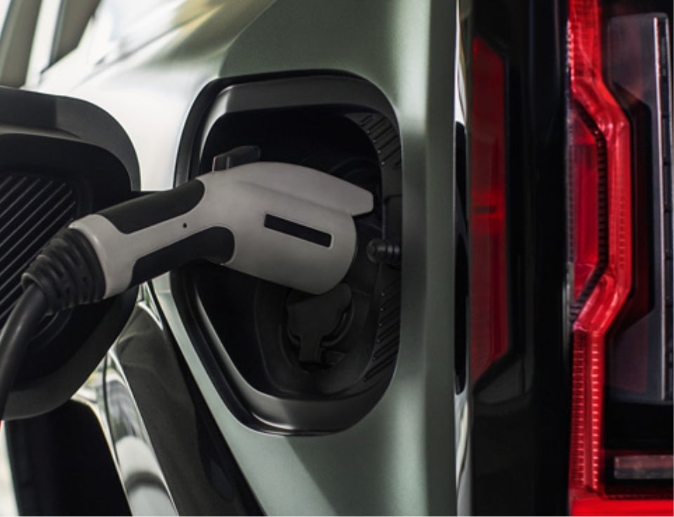 Close up of charging port with charger plugged in on a GMC Hummer EV SUV - Spurr GMC in Brockport NY